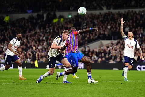 Tottenham Hotspur's Micky van de Ven, center left, fouls Crystal Palace's Ismaila Sarr resulting in a red card and a penalty  during the English Premier League soccer match between Tottenham Hotspur and Crystal Palace in London.