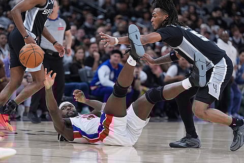 Detroit Pistons forward Isaiah Stewart (28) passes the ball past San Antonio Spurs guard Stephon Castle (5) during the second half of an NBA basketball game in San Antonio.