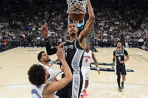 San Antonio Spurs forward Victor Wembanyama (1) scores over Detroit Pistons guard Cade Cunningham (2) during the second half of an NBA basketball game in San Antonio.