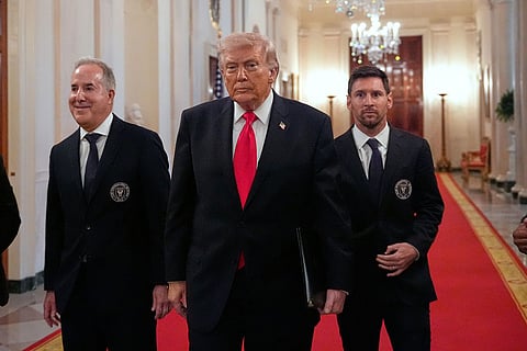 Lionel Messi, right, and Inter Miami CF owner Jorge Mas Santos arrive with President Donald Trump at an event to honor the 2025 Major League Soccer champions Inter Miami CF in the East Room of the White House in Washington.