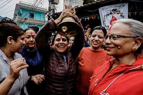 Supporters of the Rastriya Swatantra Party (RSP) ring a bell, the party’s election symbol, outside the Election Commission ahead of the announcement of results in the Nepal general elections, in Kathmandu, Nepal.