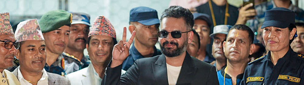 Photo: PTI : Balendra Shah, a candidate of the Rastriya Swatantra Party (RSP) from Jhapa Constituency-5, shows a certificate at the Election Commission premises after winning the constituency in the Nepal general elections, in Jhapa, Nepal. Balendra Shah 'Balen' defeated four-time prime minister K P Sharma Oli by a huge margin of about 50,000 votes. 