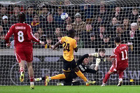 Liverpool's Mohamed Salah, right, scores their second goal of the game during an English FA Cup fifth round match against Wolverhampton Wanderers, Friday, March 6, 2026, in Wolverhampton, England.