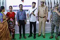 | Photo: PTI : Representative image: Telangana Chief Minister Revanth Reddy looks at a weapon after as many as 130 Maoists surrendered before him, in Hyderabad. 