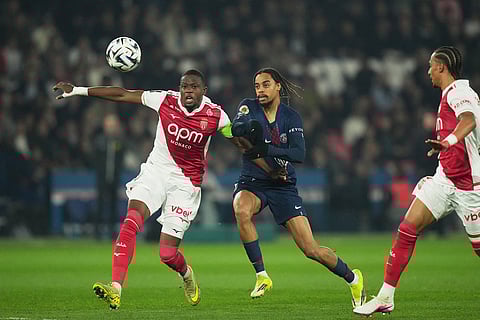 PSG's Bradley Barcola, center,, and Monaco's Denis Zakaria, left, compete for the ball during the French League One soccer match between Paris Saint-Germain and Monaco in Paris.