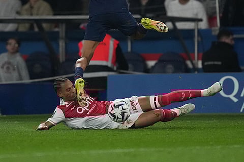 Monaco's Thilo Kehrer, tackles PSG's Bradley Barcola during the French League One soccer match between Paris Saint-Germain and Monaco in Paris.