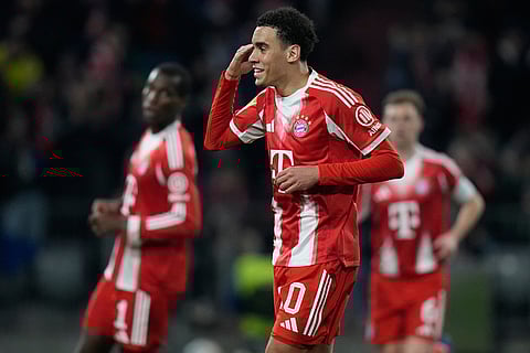 Bayern's Jamal Musiala celebrates after scoring from the penalty spot his side's third goal during the Bundesliga soccer match between FC Bayern Munich and Borussia Moenchengladbach in Munich, Germany.