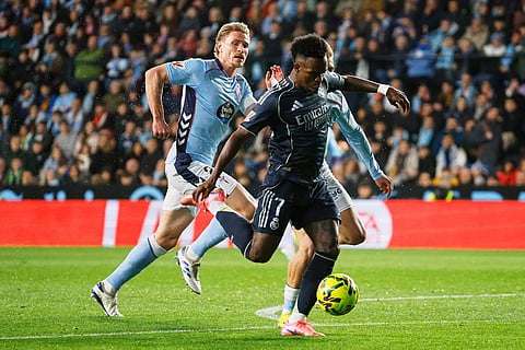 Real Madrid's Vinicius Junior, right, vies for the ball with Celta's Carl Starfelt during a Spanish La Liga soccer match between Celta Vigo and Real Madrid in Vigo, Spain.