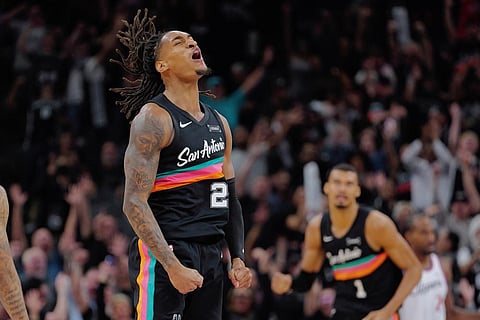 San Antonio Spurs guard Devin Vassell celebrates a 3-point basket during the second half of an NBA basketball game against the Los Angeles Clippers in San Antonio.