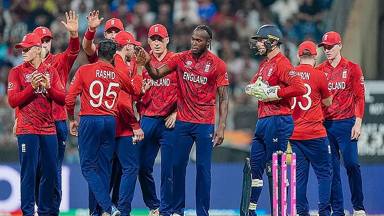 England's Adil Rashid celebrates with teammates the wicket of West Indies' Roston Chase during ICC T20 World Cup 2026 at the Wankhede Stadium. - PTI