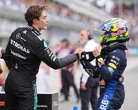 Mercedes driver George Russell, left, of Britain is congratulated by third placed Red Bull driver Isack Hadjar of France after winning the qualifying session for the Australian Formula One Grand Prix at Albert Park, in Melbourne, Australia.