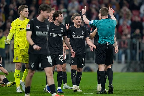 Moenchengladbach player argues with referee Robert Schroeder after team mate Rocco Reitz received the red card during the Bundesliga soccer match between FC Bayern Munich and Borussia Moenchengladbach in Munich, Germany.