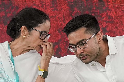 West Bengal Chief Minister Mamata Banerjee, left, with TMC National General Secretary Abhishek Banerjee during a sit-in protest against the alleged arbitrary deletions from the post-SIR electoral rolls in the state, in Kolkata.