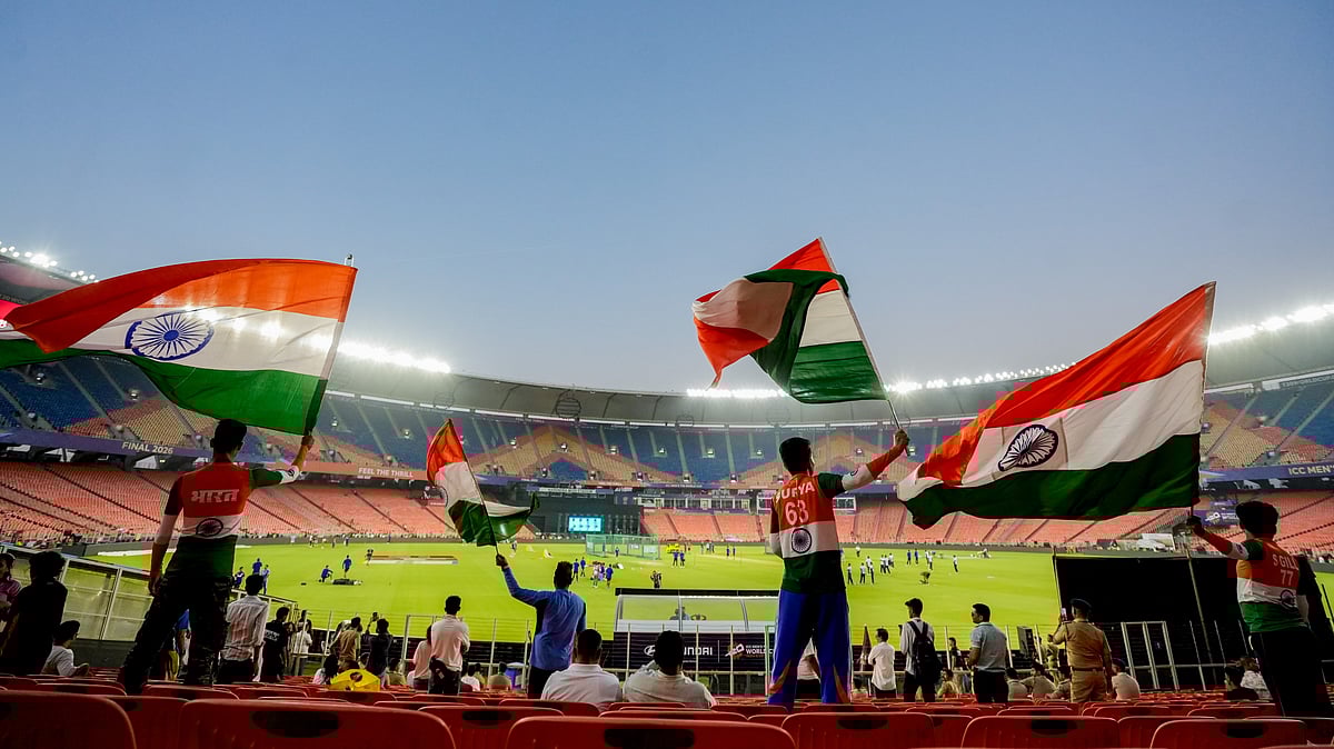 Fans wave the national flag on the eve of the ICC T20 World Cup 2026 final between India and New Zealand, at the Narendra Modi Stadium in Ahmedabad. - PTI