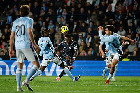 Real Madrid's Vinicius Junior, center, kicks the ball during a Spanish La Liga soccer match between Celta Vigo and Real Madrid in Vigo, Spain.