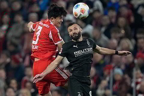 Bayern's Kim Min-jae, left, and Moenchengladbach's Franck Honorat challenge for the ball during the Bundesliga soccer match between FC Bayern Munich and Borussia Moenchengladbach in Munich, Germany.