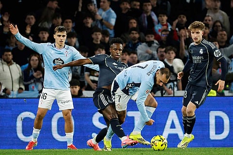 Real Madrid's Vinicius Junior, second left, vies for the ball with Celta's Borja Iglesias during a Spanish La Liga soccer match between Celta Vigo and Real Madrid in Vigo, Spain.