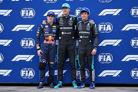Qualifying session winner Mercedes driver George Russell, centre, of Britain stands with teammate and second placed Andrea Kimi Antonelli, right, of Italy and third placed Red Bull driver Isack Hadjar of France at the Australian Formula One Grand Prix at Albert Park, in Melbourne, Australia.