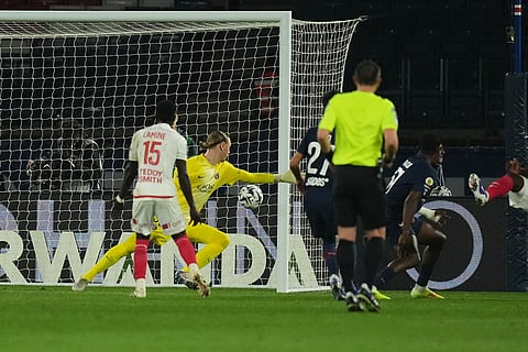 PSG's goalkeeper Matvey Safonov, back, fails to save a goal scored by Monaco's Maghnes Akliouche during the French League One soccer match between Paris Saint-Germain and Monaco in Paris.