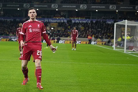 Liverpool's Andrew Robertson celebrates after scoring during the English FA Cup soccer match between Wolves and Liverpool in Wolverhampton, England.