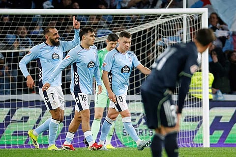 Celta's Borja Iglesias, left, celebrates after scoring his side's first goal during a Spanish La Liga soccer match between Celta Vigo and Real Madrid in Vigo, Spain.