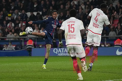 PSG's Bradley Barcola, left, attempts a shot on goal during the French League One soccer match between Paris Saint-Germain and Monaco in Paris.