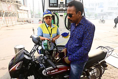 A woman worker fills fuel at a petrol pump on the occasion of International Women's Day, in Prayagraj, Uttar Pradesh.