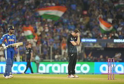 New Zealand's James Neesham reacts after New Zealand's captain Mitchel Santner drops a catch during the T20 World Cup cricket final match between India and New Zealand in Ahmedabad.