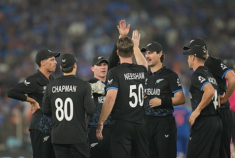 New Zealand's James Neesham, center, celebrates the wicket of India's Sanju Samson with teammates during the T20 World Cup cricket final match between India and New Zealand in Ahmedabad.