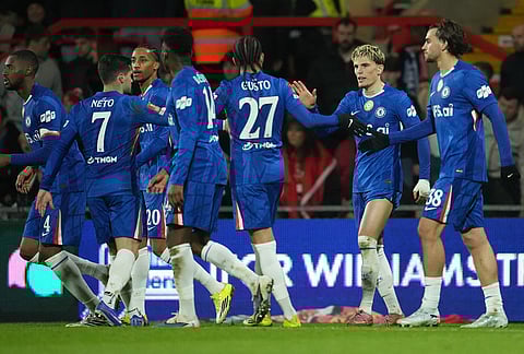 Chelsea players celebrate after a goal during the fifth round FA Cup soccer match between Wrexham and Chelsea in Wrexham, Wales.