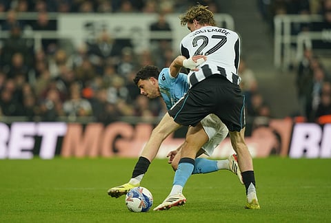 Manchester City's Matheus Nunes and Newcastle's Nick Woltemade fight for the ball during the fifth round FA Cup soccer match between Newcastle and Manchester City in Newcastle, England.