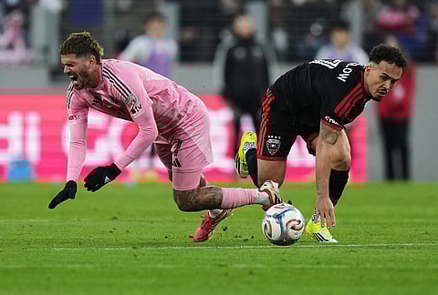 Inter Miami midfielder Rodrigo de Paul, left, falls as D.C. United forward João Peglow, right, commits a foul against him during the second half of an MLS soccer match, in Baltimore. 