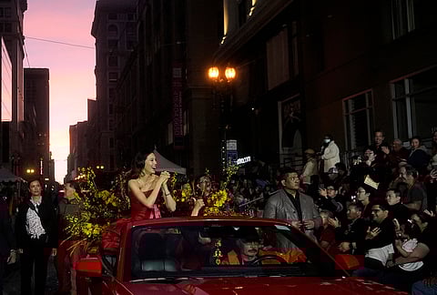 Olympic gold medalist and Grand Marhsal Eileen Gu, middle left, gestures during the Chinese New Year Parade in San Francisco.