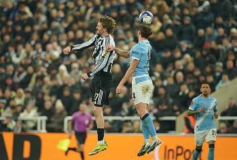 Newcastle's Nick Woltemade, left, and Manchester City's Nico Gonzalez jump for the ball during the fifth round FA Cup soccer match between Newcastle and Manchester City in Newcastle, England.
