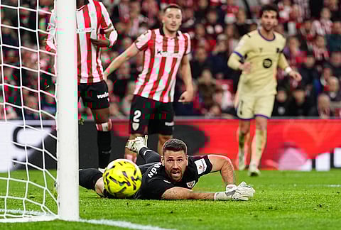 Athletic Bilbao's goalkeeper Unai Simon dives for the ball during the Spanish La Liga soccer match between Athletic Bilbao and Barcelona in Bilbao, Spain.