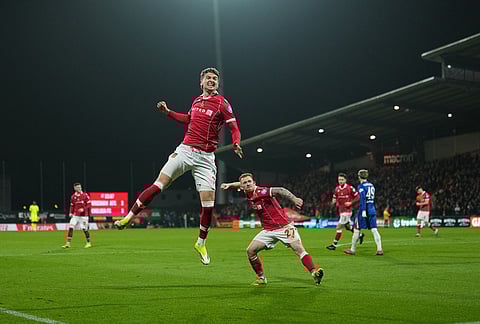 Wrexham's Lewis Brunt celebrates a a goal that wa disallowed later during the fifth round FA Cup soccer match between Wrexham and Chelsea in Wrexham, Wales.