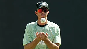 AP Photo/Ajit Solanki : New Zealand's captain Mitchell Santner toss a ball during a practice session ahead of the T20 World Cup cricket final match against India in Ahmedabad, India, Saturday, March 7, 2026.