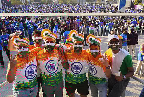 Indian cricket fans pose for photograph as they arrive for the T20 World Cup cricket final match between India and New Zealand in Ahmedabad.