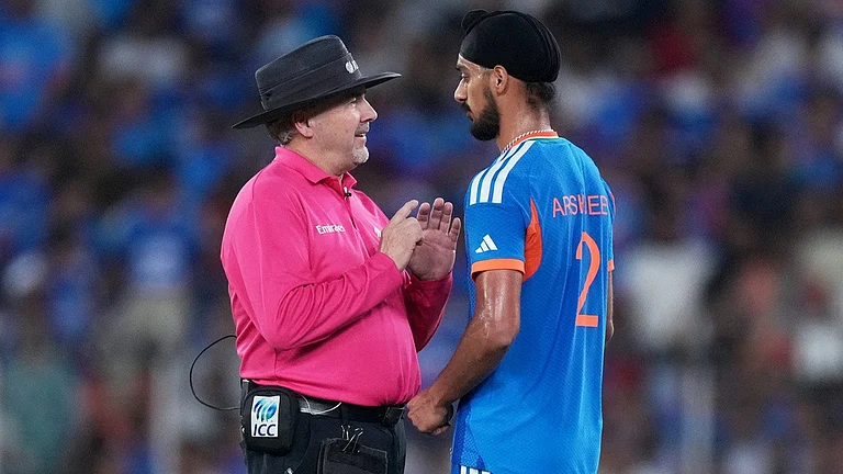 Umpire Richard Illingworth speaks with India's Arshdeep Singh after a misguided throw by the latter hit New Zealand's Daryl Mitchell's bat during the T20 World Cup cricket final match between India and New Zealand in Ahmedabad, India, Sunday, March 8, 2026. - AP Photo/Ajit Solanki