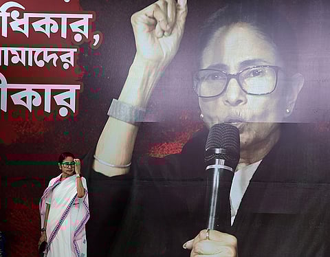 West Bengal Chief Minister Mamata Banerjee, centre, during a sit-in for the third consecutive day, in Kolkata. Banerjee staged the sit-in to protest against the LPG price hike on the occasion of International Women's Day. 