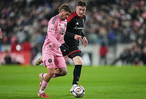 Inter Miami midfielder Rodrigo de Paul, left, advances past D.C. United defender Nikola Marković, right, during the second half of an MLS soccer match, in Baltimore.