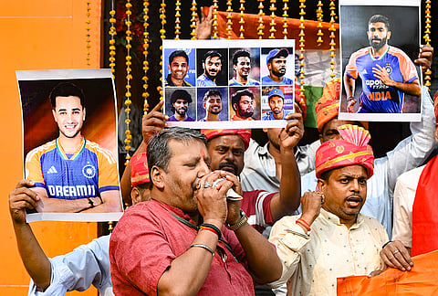 People hold posters of the Indian cricket team, praying for India's victory in the ICC Men's T20 World Cup 2026 final against New Zealand, in Patna.