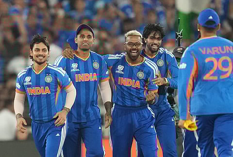 India's players celebrate after winning the T20 World Cup cricket final match against New Zealand in Ahmedabad.