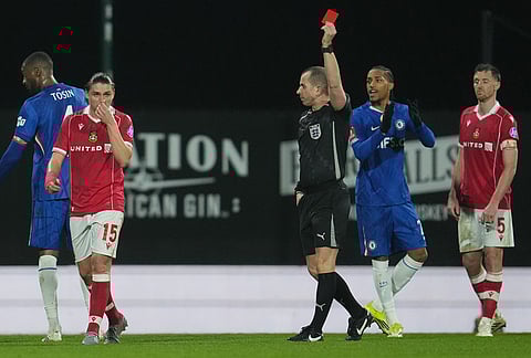 Wrexham's George Dobson receives a red card during the fifth round FA Cup soccer match between Wrexham and Chelsea in Wrexham, Wales.