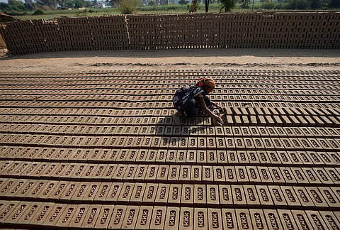 A woman works at a brick factory on International Women's Day on the outskirts of Jammu.
