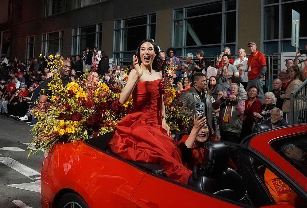 Olympic gold medalist and Grand Marhsal Eileen Gu waves during the Chinese New Year Parade in San Francisco. - | Photo: AP/Jeff Chiu