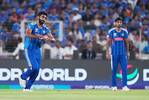 India's Jasprit Bumrah, left, bowls a delivery during the T20 World Cup cricket final match between India and New Zealand in Ahmedabad.
