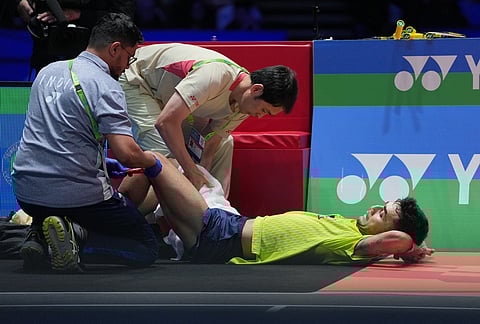 India's Lakshya Sen receives medical treatment as he plays against Canada's Victor Lai during the men's singles semifinal match at the All England Open Badminton Championships in Birmingham, England.