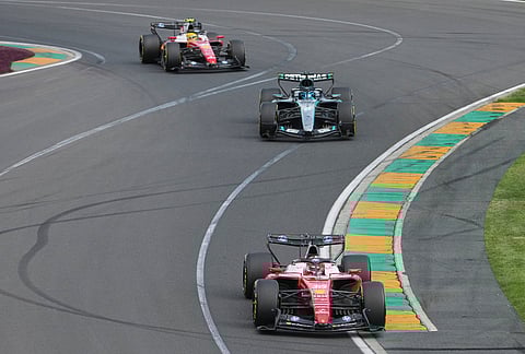 Ferrari driver Charles Leclerc, front, of Monaco leads Mercedes driver George Russell of Britain and teammate Lewis Hamilton of Britain during the Australian Formula One Grand Prix at Albert Park, in Melbourne, Australia.