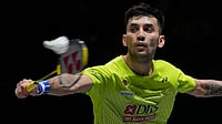 Photo: AP : India's Lakshya Sen plays against Canada's Victor Lai during the men's singles semifinal match at the All England Open Badminton Championships in Birmingham, England.